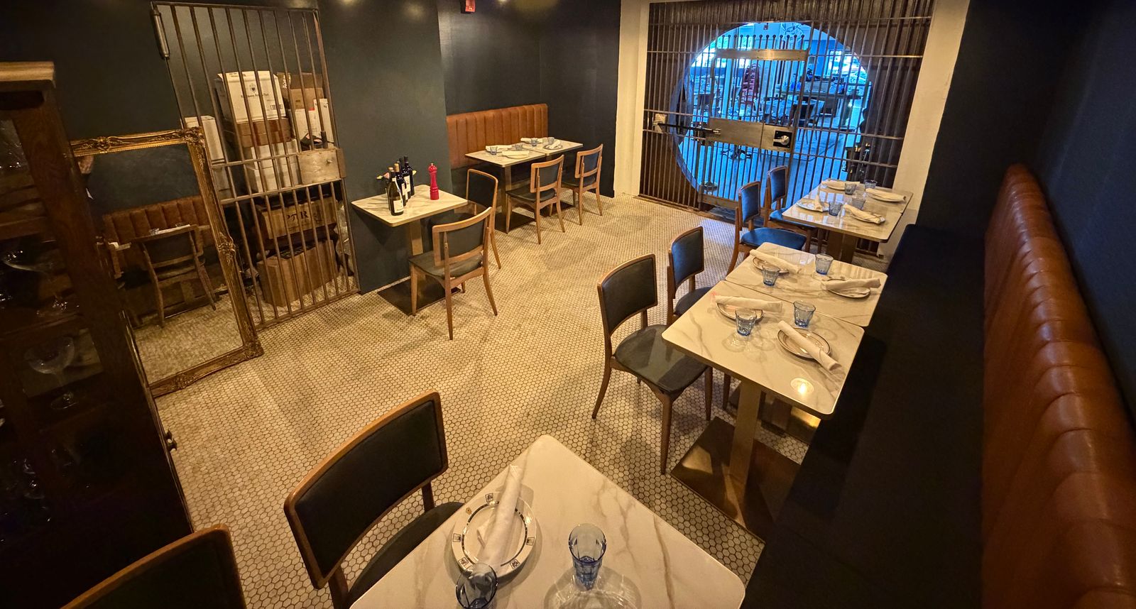 The Vault dining room at Marée: leather banquettes, marble tables, and the original tile floor
